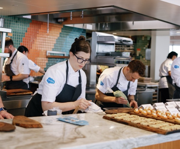 Salesforce chefs preparing and plating dishes for service in a commercial kitchen