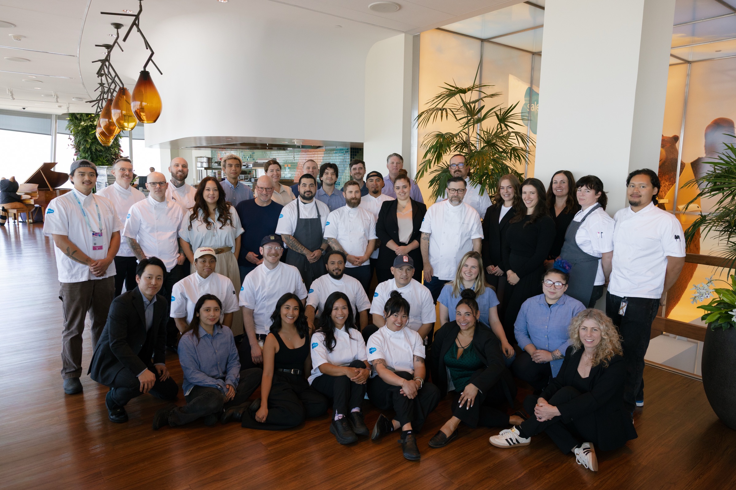 Salesforce Culinary Team members gathered for a group portrait on an Ohana Floor